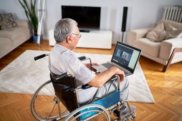 Disabled wheelchair user having an online chat