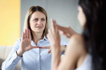 Two women communicating with each other in British Sign Language