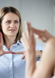 Two women communicating with each other in British Sign Language